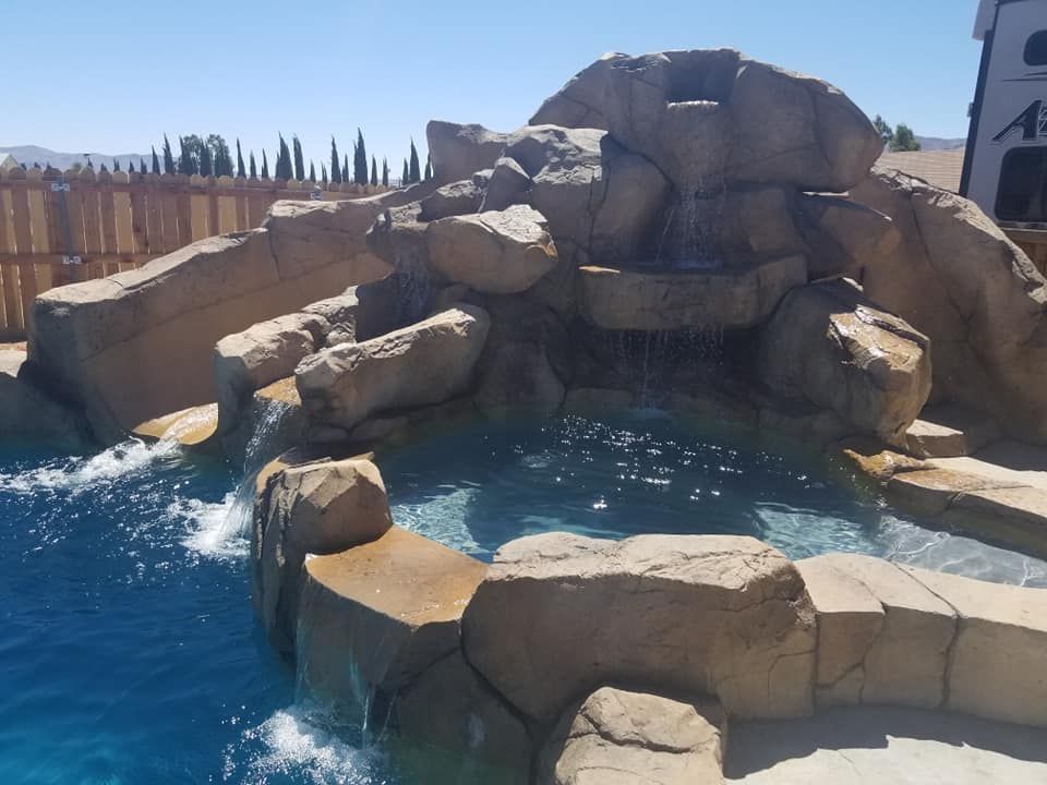 A waterfall in the middle of a swimming pool