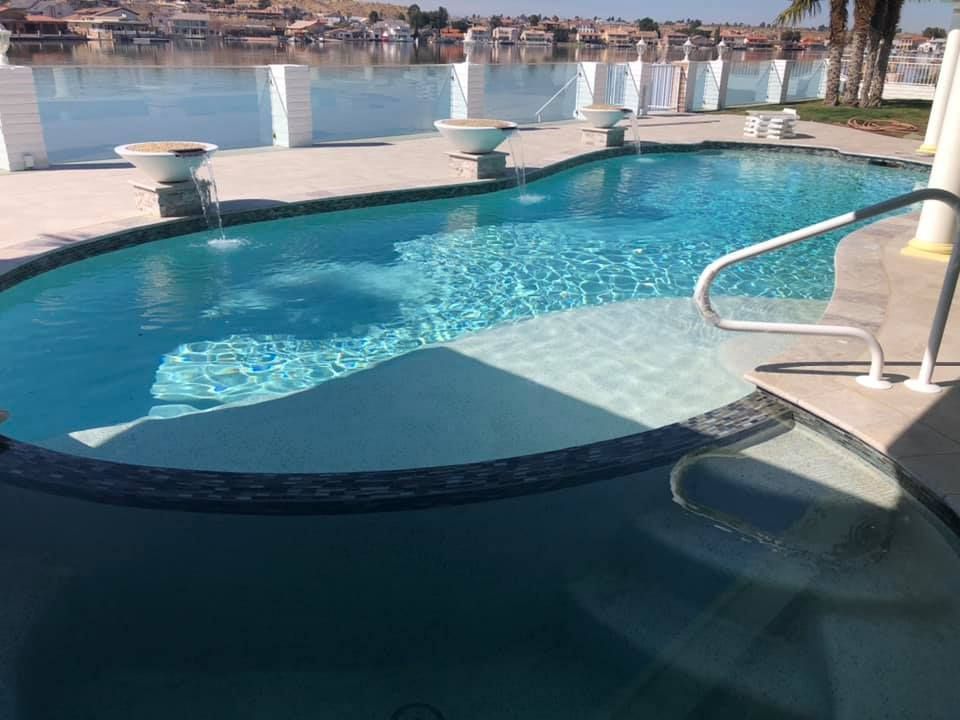 A large swimming pool with a staircase leading to it.