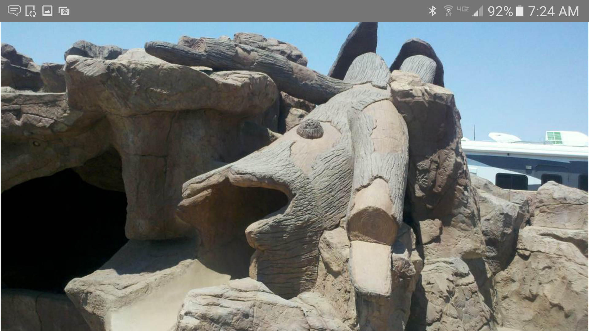 A phone screen shows a statue of a bull