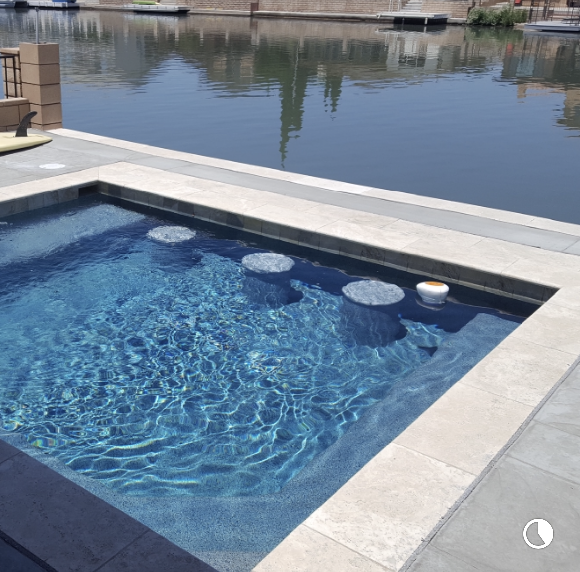 A large swimming pool surrounded by a body of water