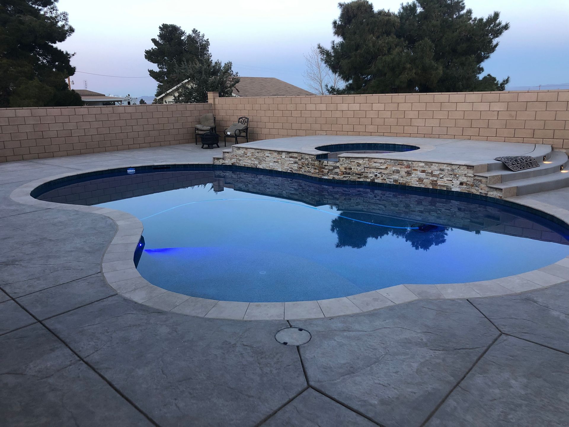 A large swimming pool with blue lights on it