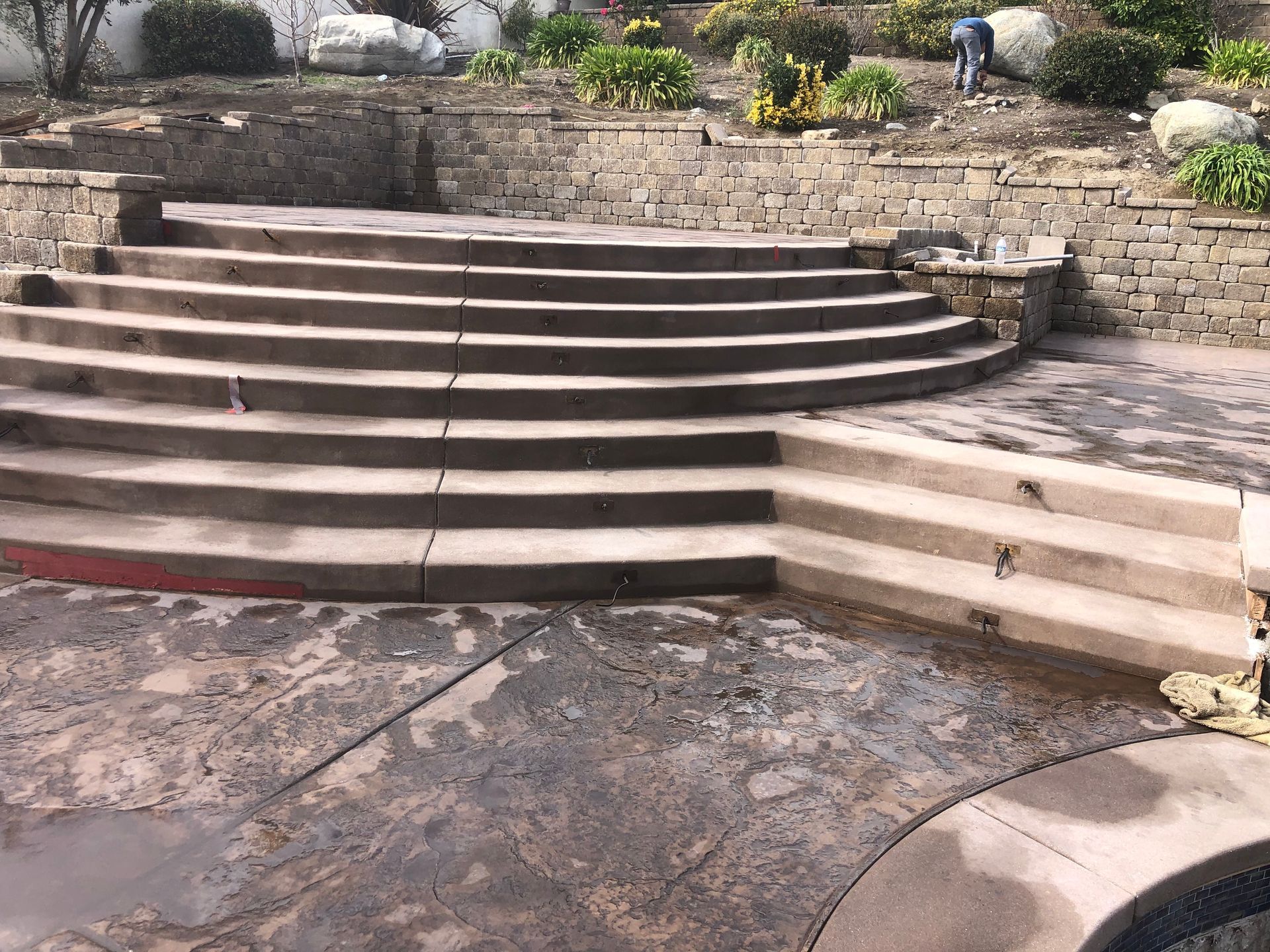 A set of stairs leading up to a pool in a backyard.