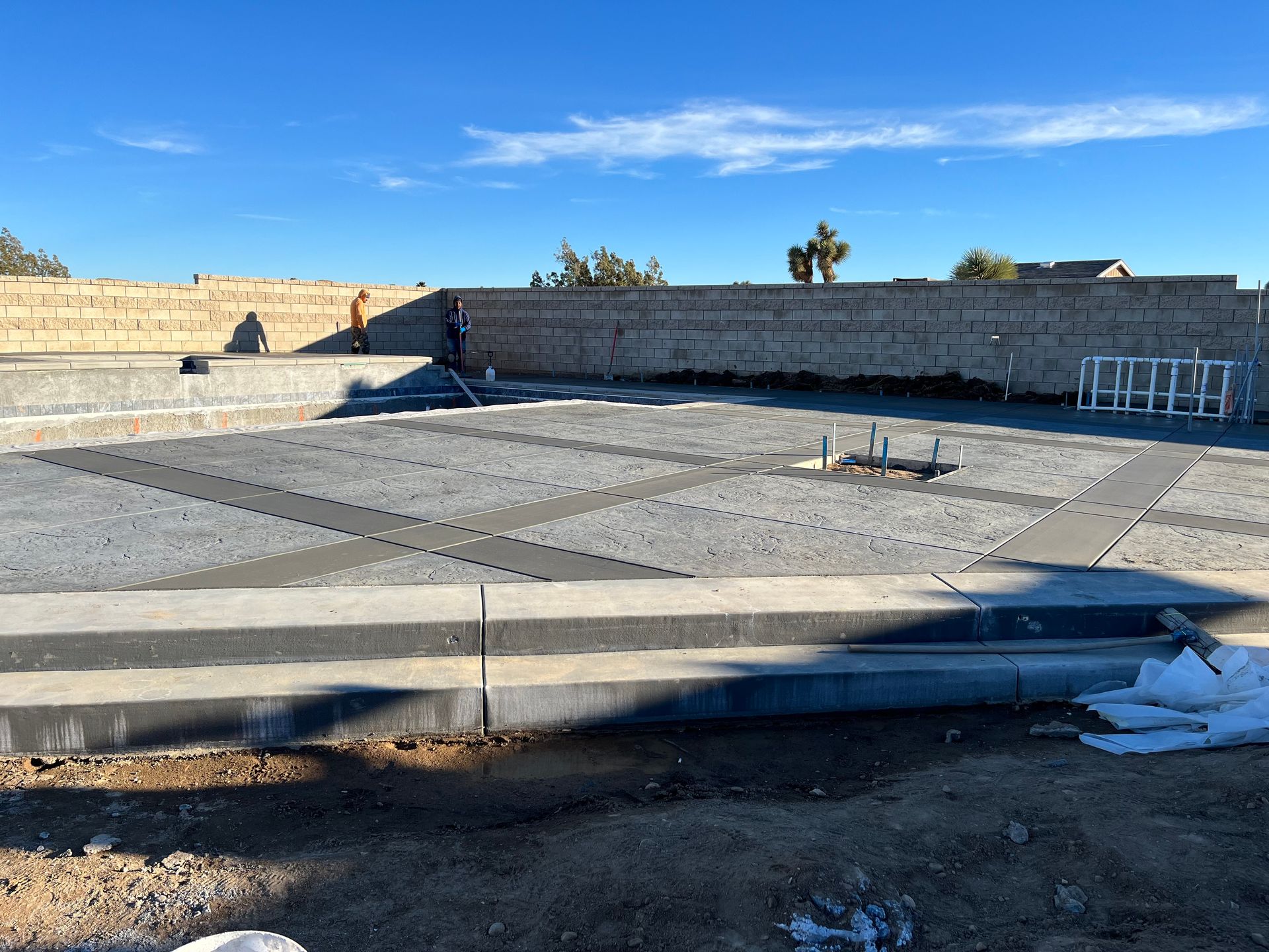 A construction site with a blue sky and a ladder in the background.