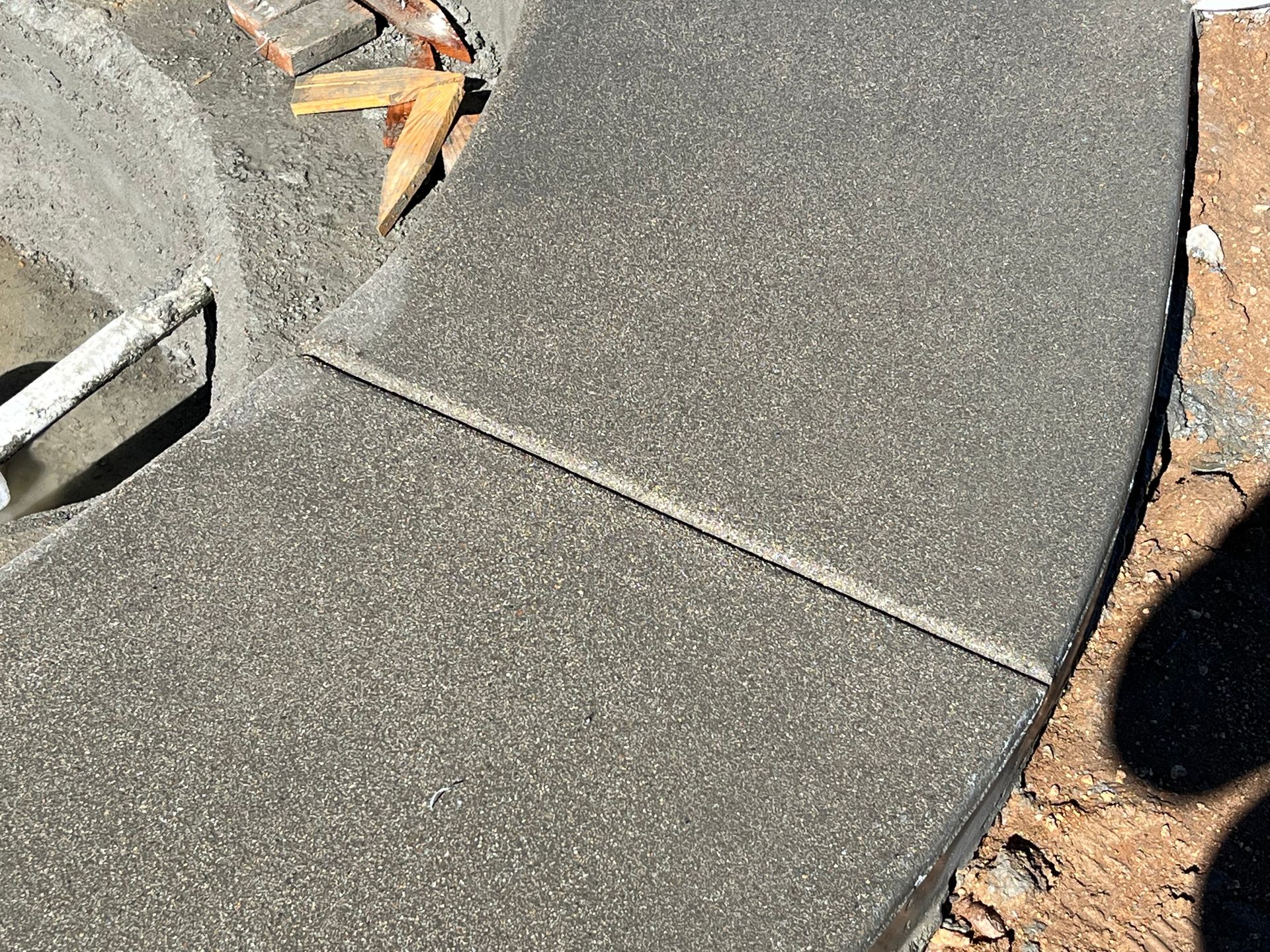 A close up of a concrete surface with tools on it.