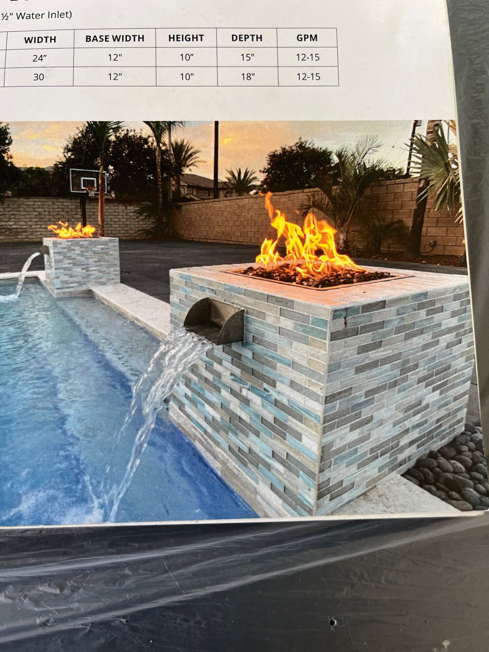 A picture of a fire pit next to a pool.