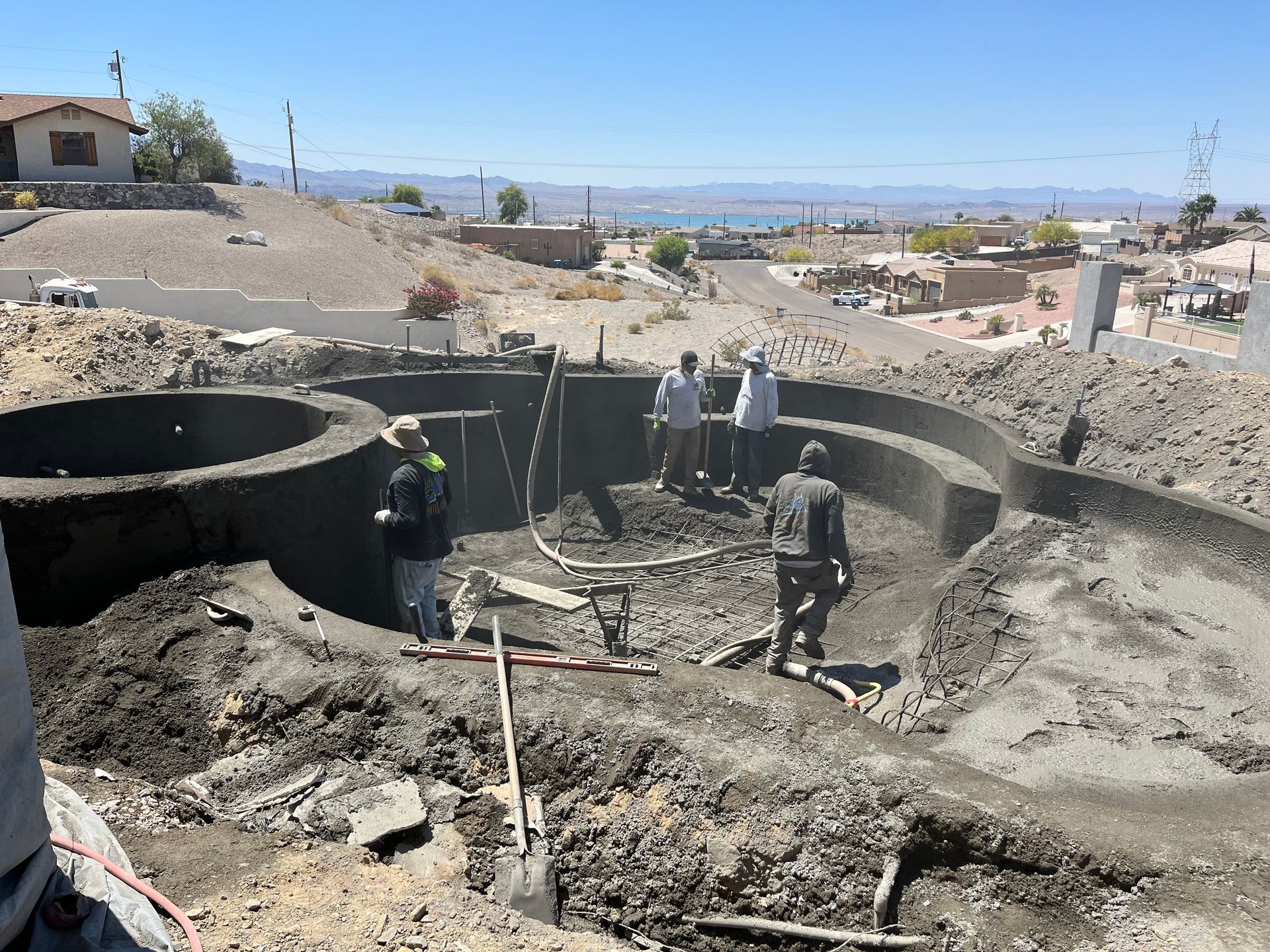 A group of people are working on a large hole in the ground.