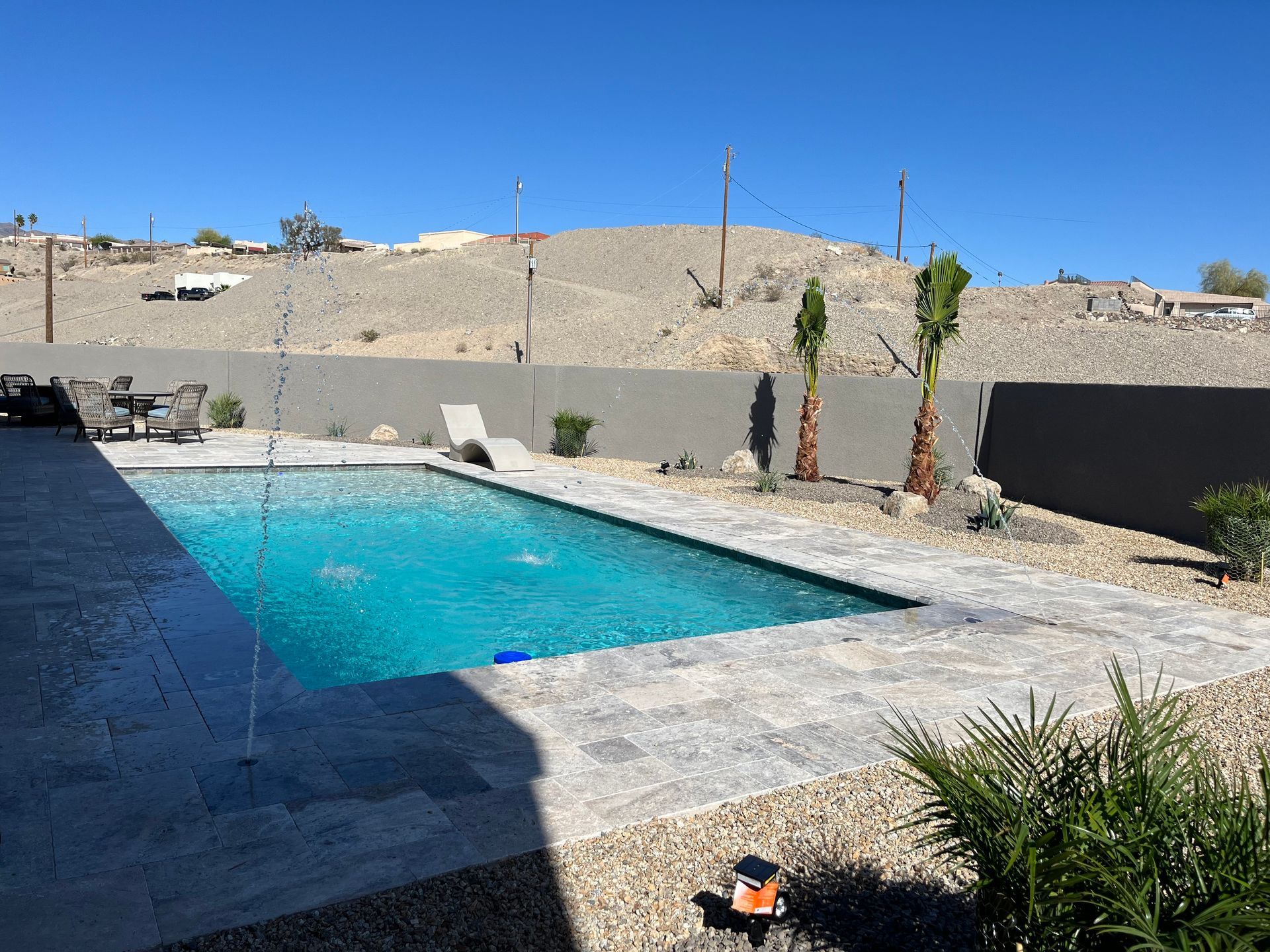 A large swimming pool in the backyard of a house