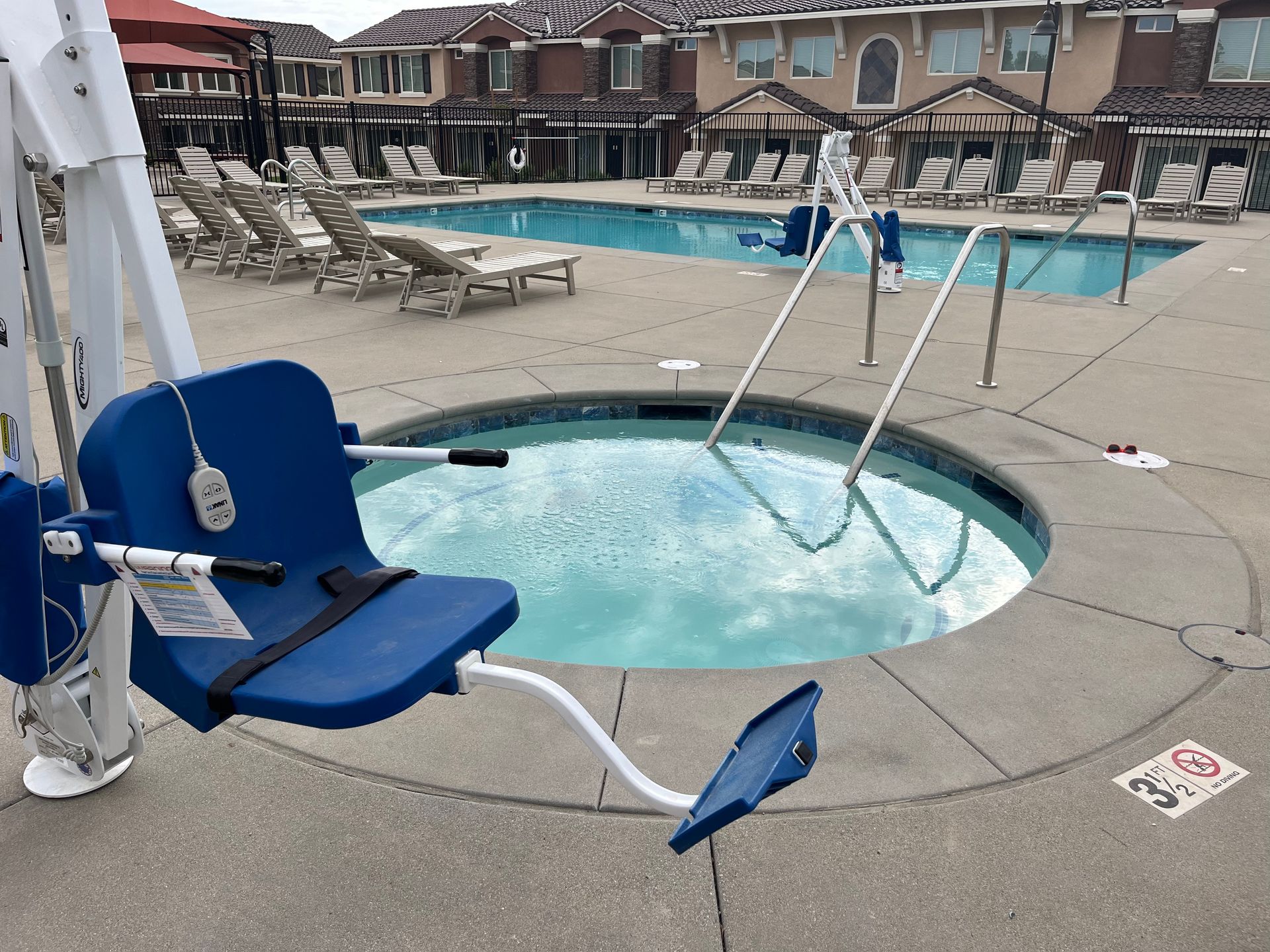 A blue chair is sitting next to a swimming pool