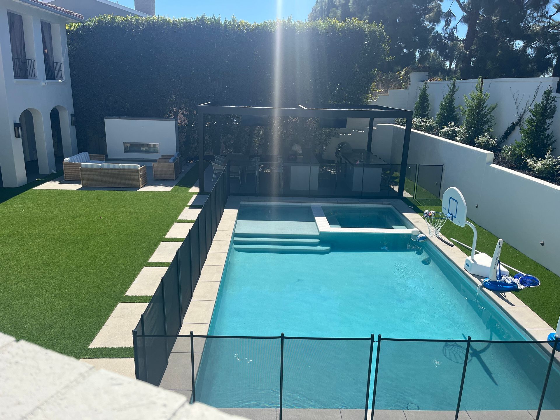 A large swimming pool with a fence around it