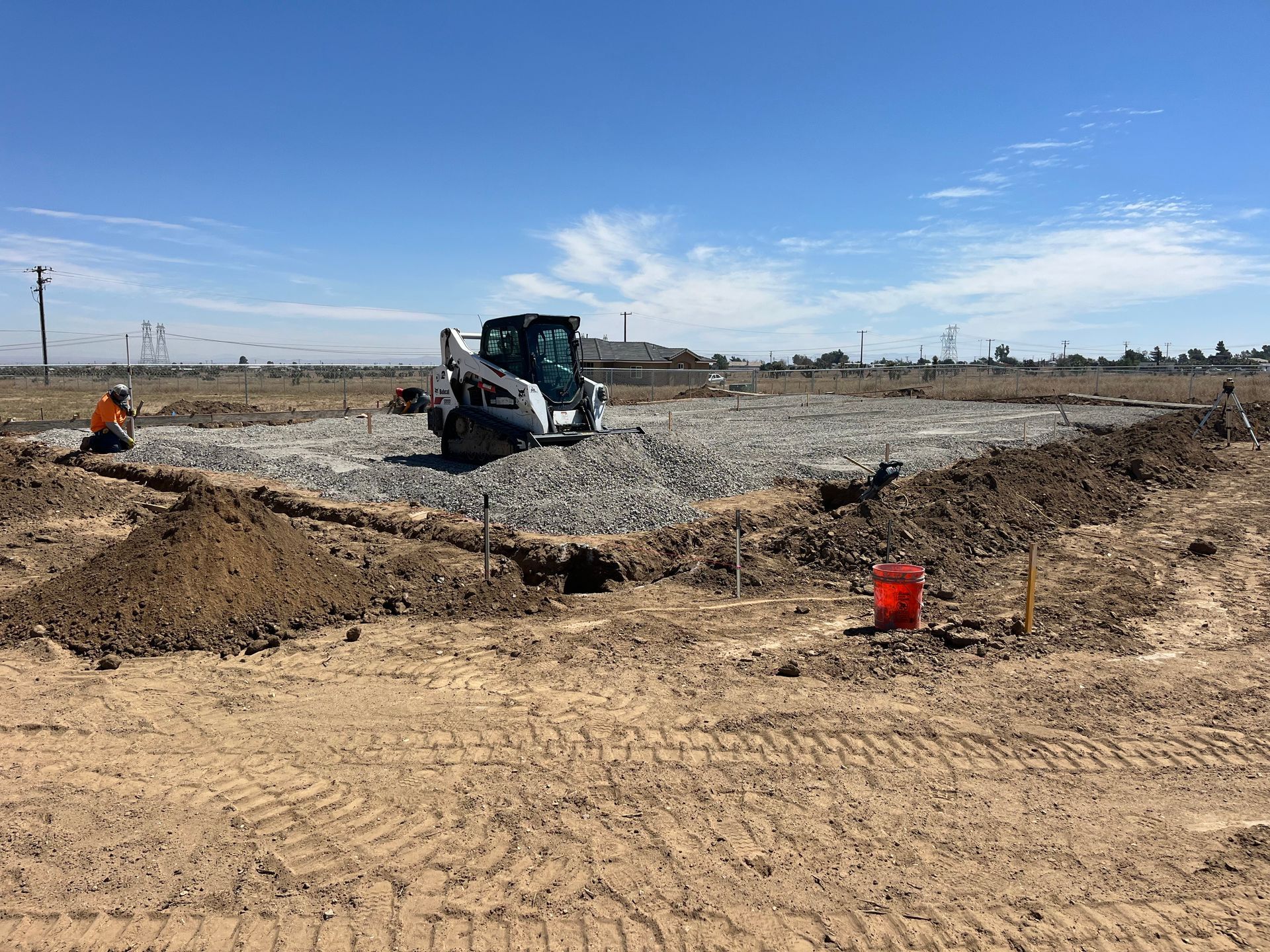 A bulldozer is digging a hole in a dirt field.