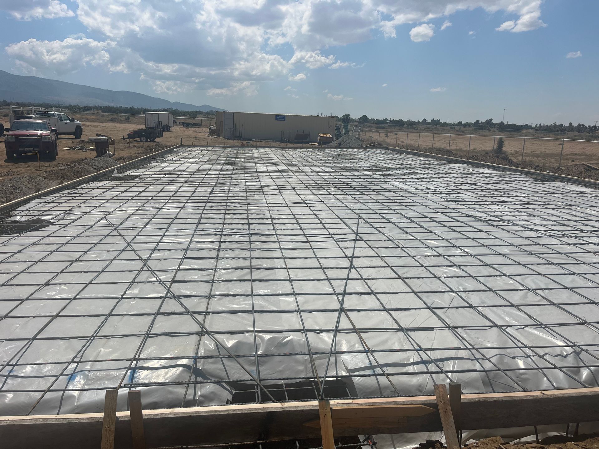 A large concrete slab is being built on a construction site.