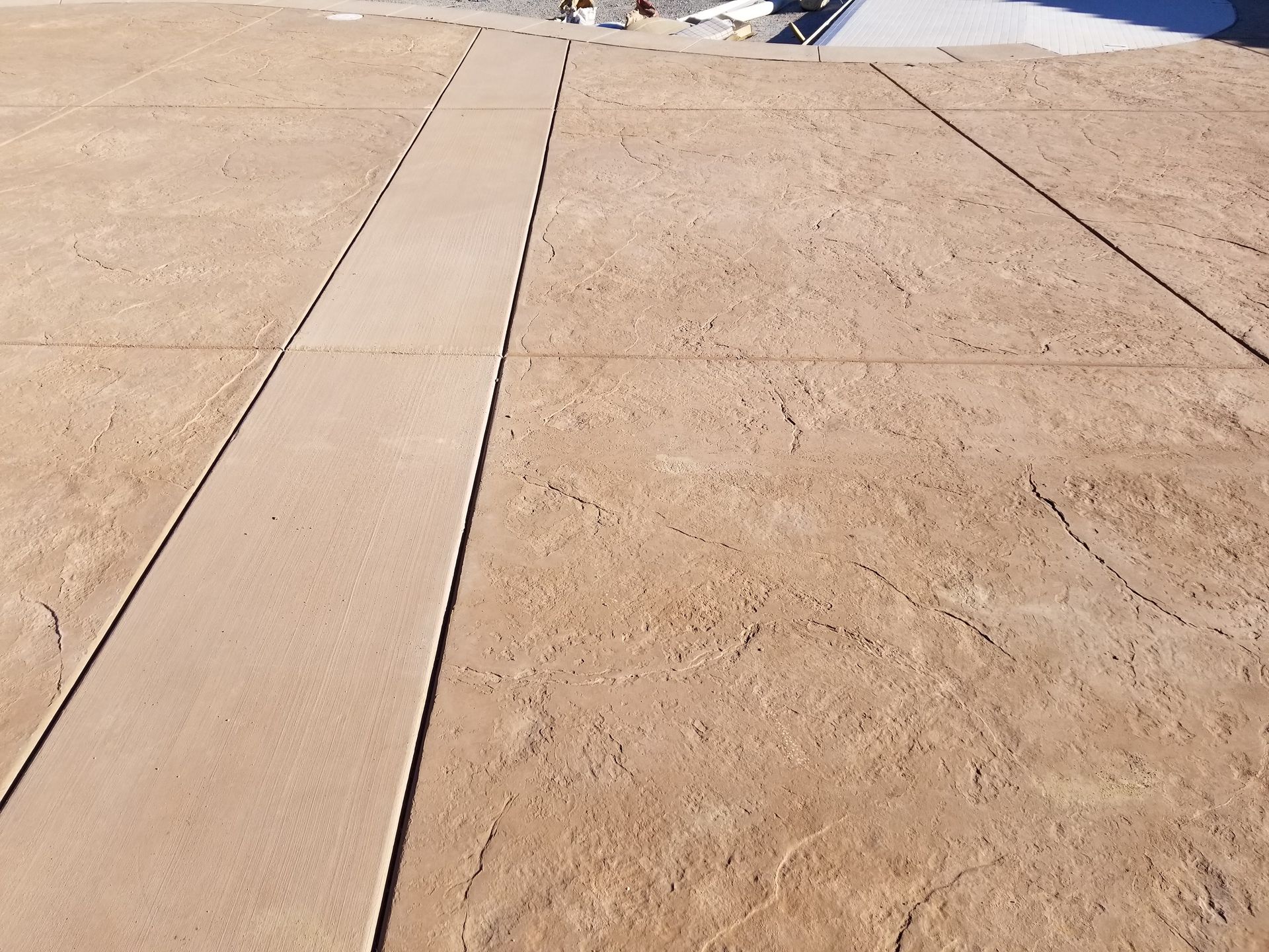 A concrete driveway with a diagonal line in the middle