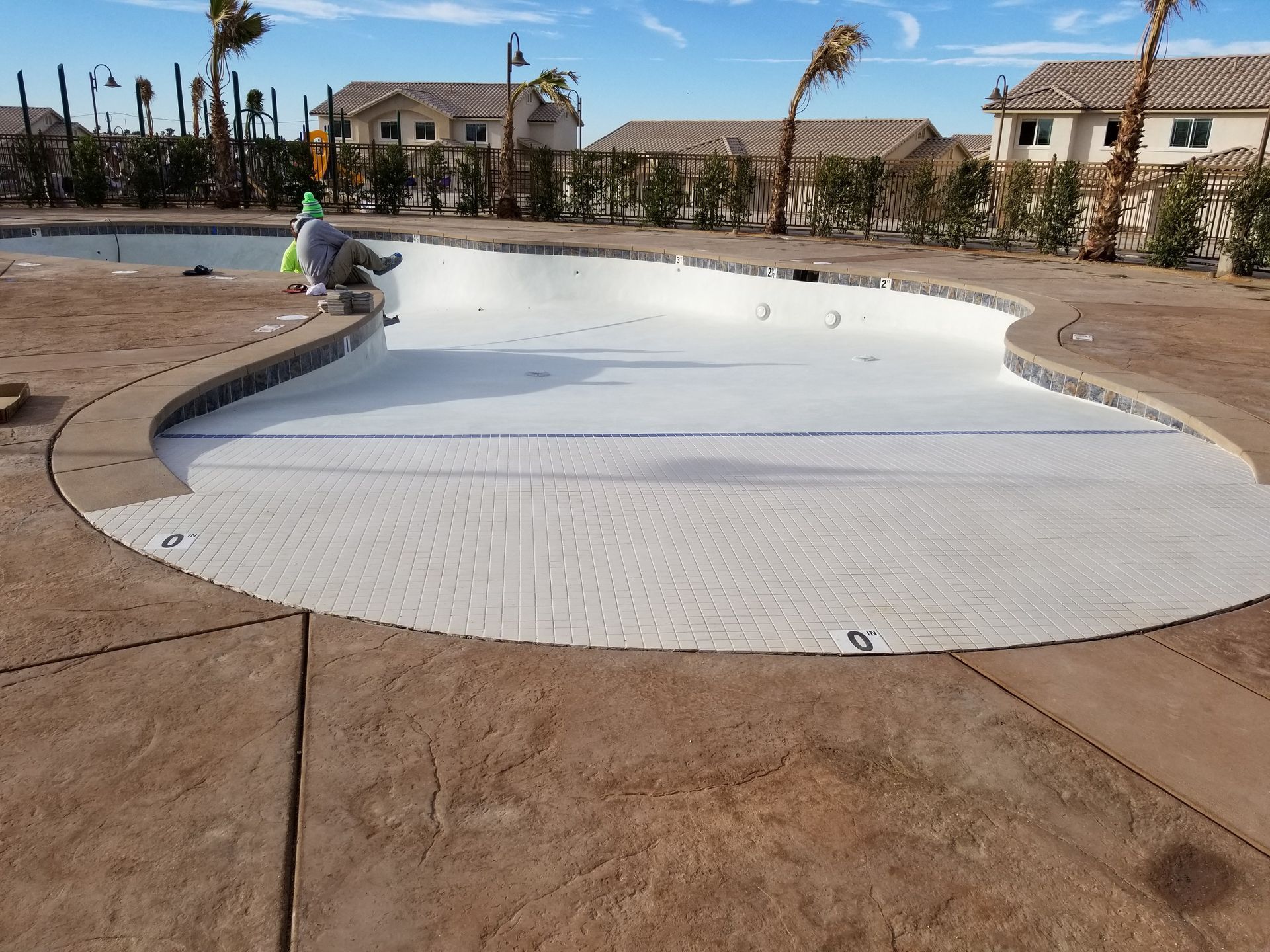 A large swimming pool is being painted white