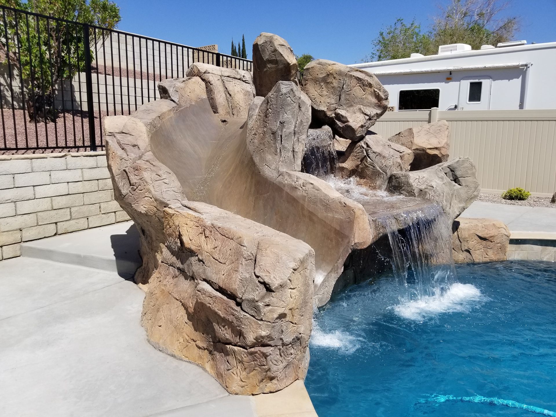 A patio with a table and chairs under a pergola.