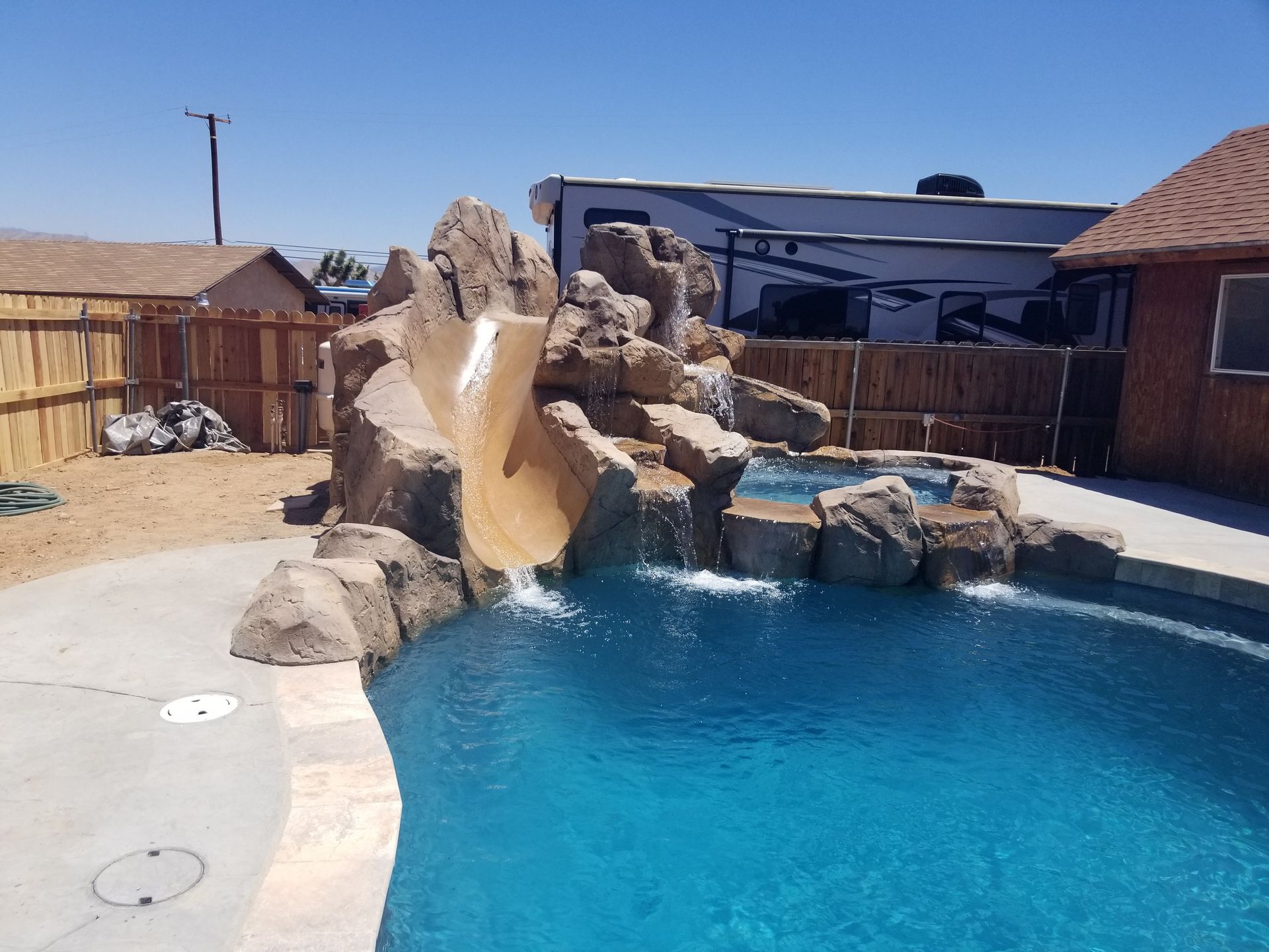 A swimming pool with a slide in the middle of it