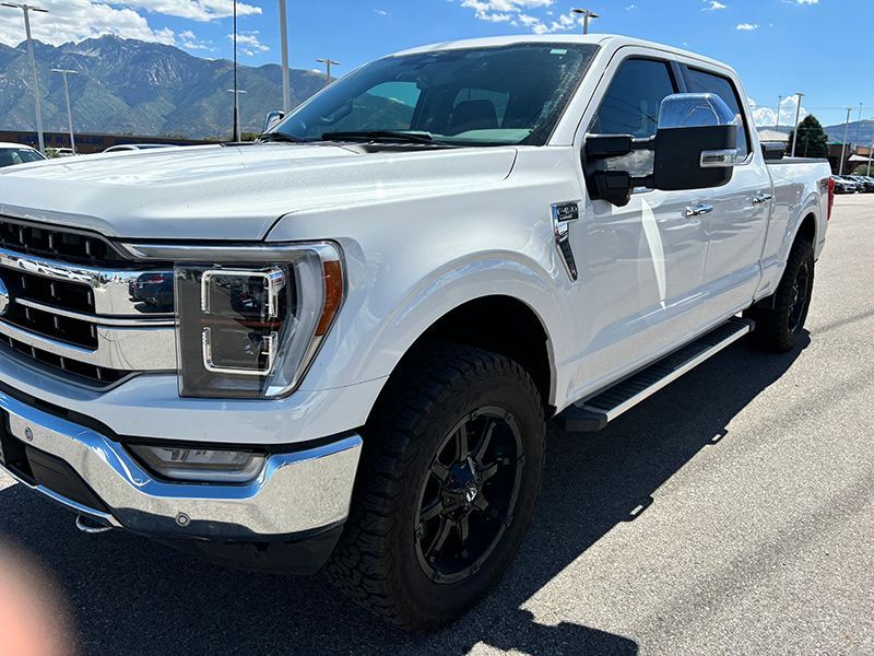 A white ford f150 truck is parked in a parking lot.