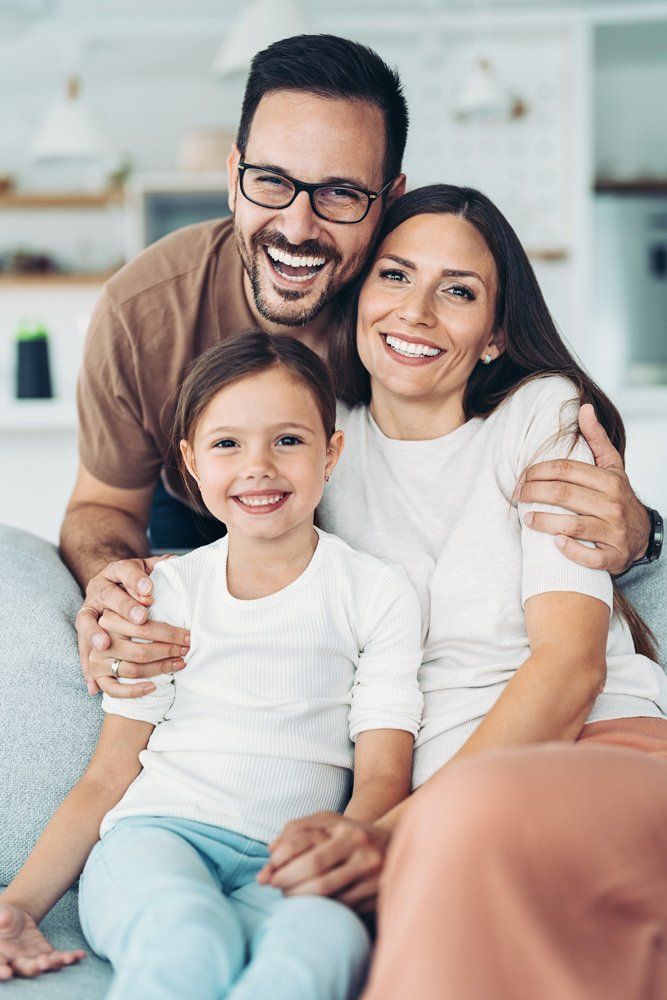 Smiling Family At Home — Aurora, CO — Katherine Moskal Health Plans