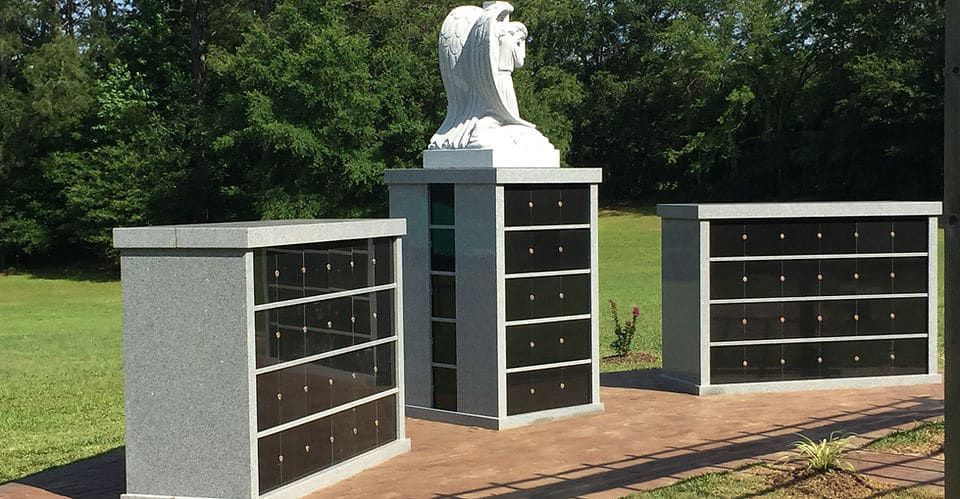 A cemetery with a statue of an angel in the middle