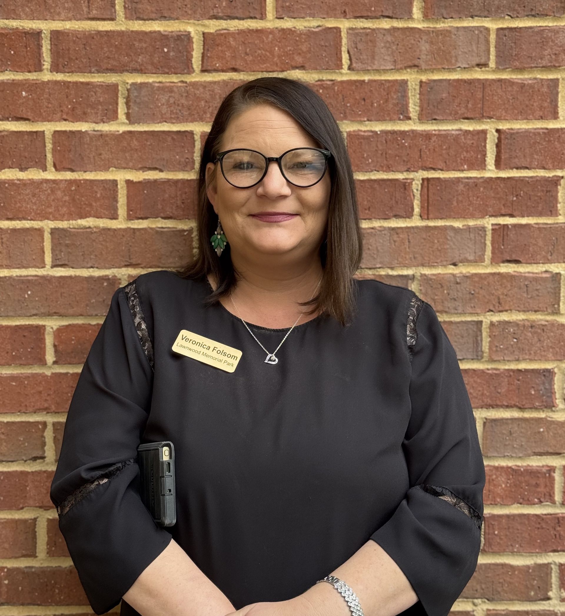 A silhouette of a woman in a suit without a face.
