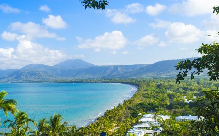 An Aerial View of A Tropical Beach with Mountains in The Background — Alfie's Towing In Cairns North, QLD