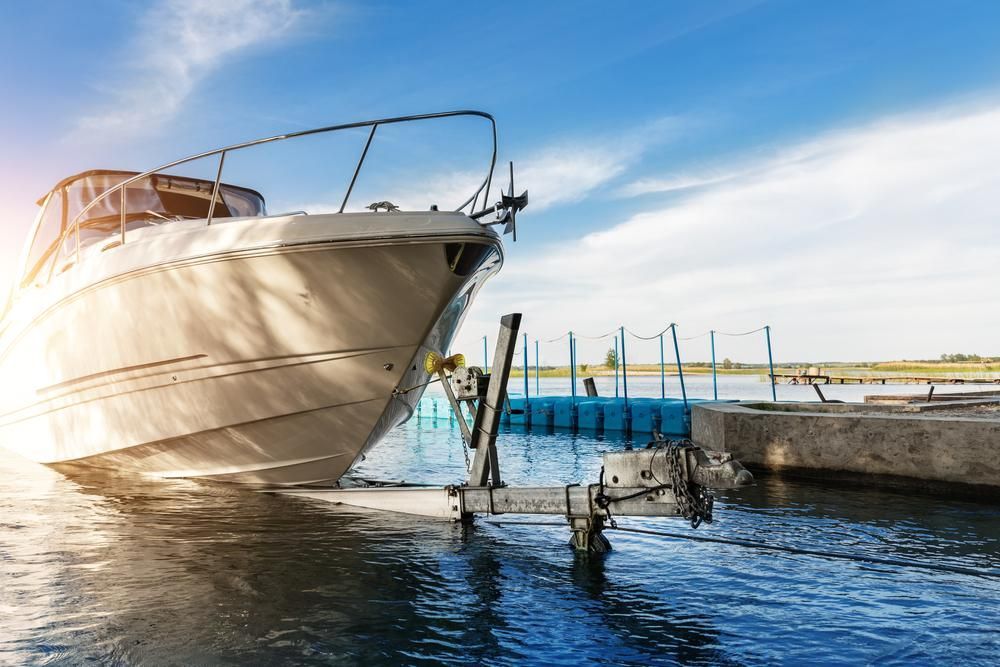 A Boat Is Docked in A Harbor with A Trailer Attached to It — Alfie's Towing In Innisfail, QLD