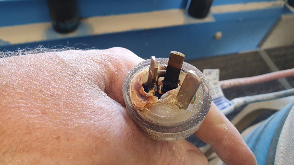 Man Holding Damaged Power Cord — Coastal Test & Tag in Bonville, NSW