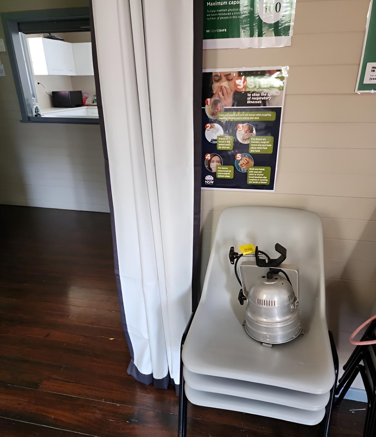 A Room With a Stack of Chairs and a Poster on the Wall — Coastal Test & Tag in Kempsey, NSW