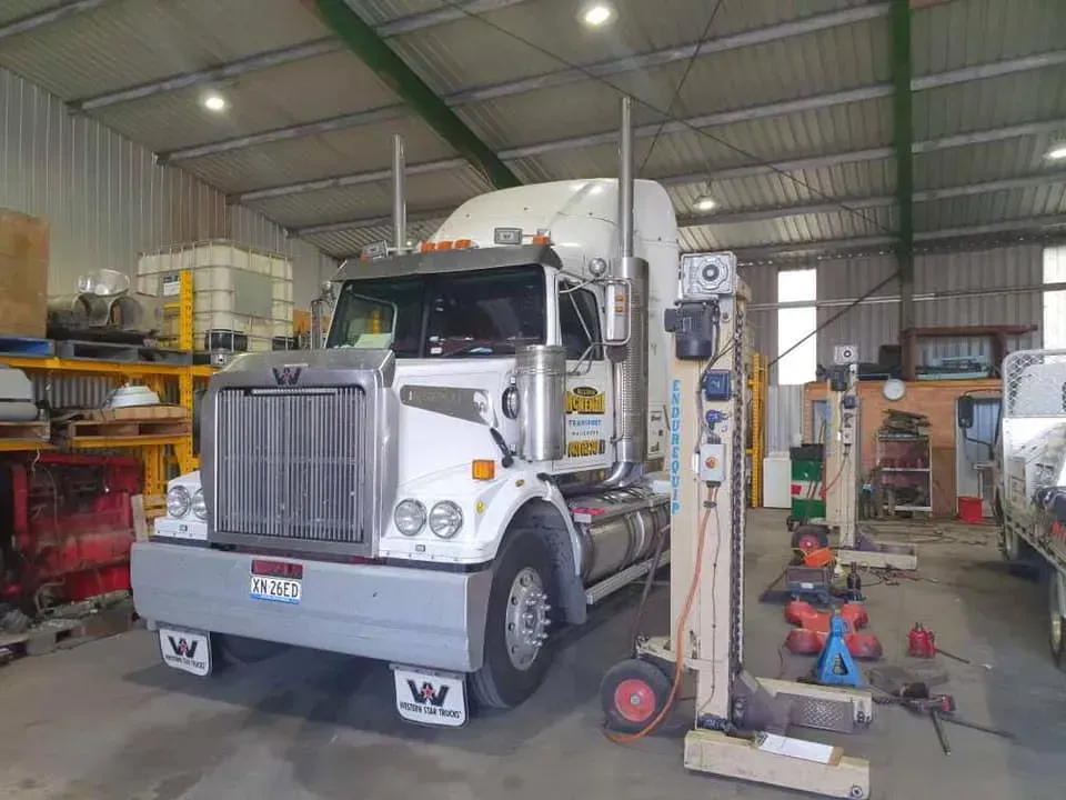 A Semi-truck Parked Inside a Well-lit Workshop — Mid North Coast Heavy Vehicle Repairs In Kew, NSW