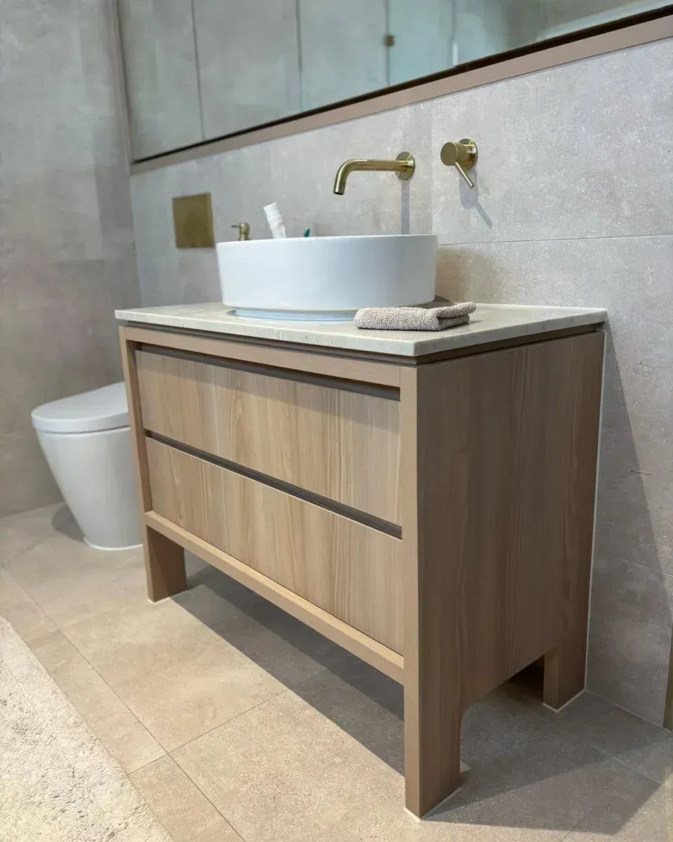 Bathroom vanity with a vessel sink, two drawers, and gold faucet, in a modern setting — Canelo Cabinetry In Rocklea, QLD