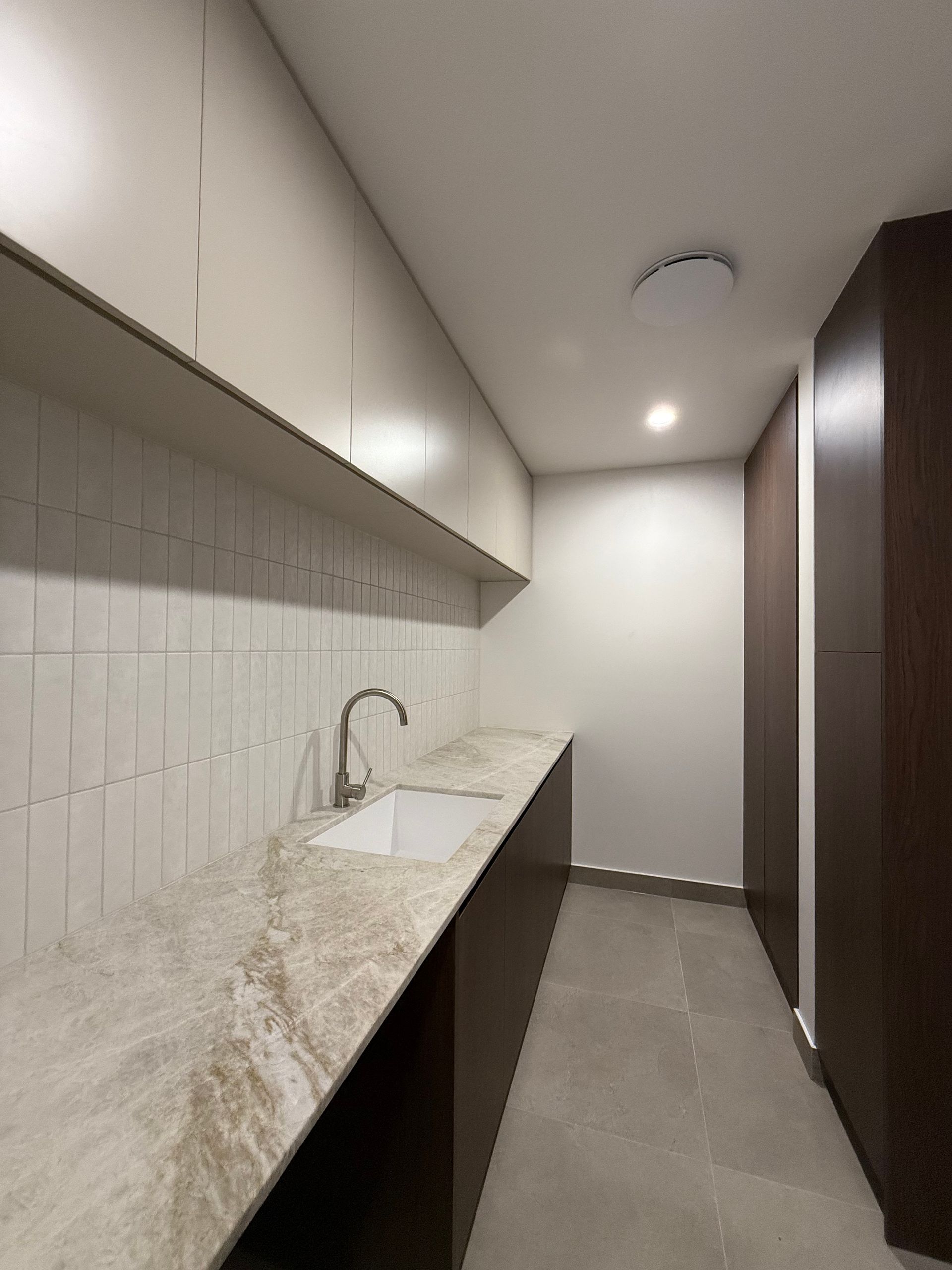 Modern kitchen with beige countertop, white sink, dark brown cabinets, and white backsplash — Canelo Cabinetry In Rocklea, QLD
