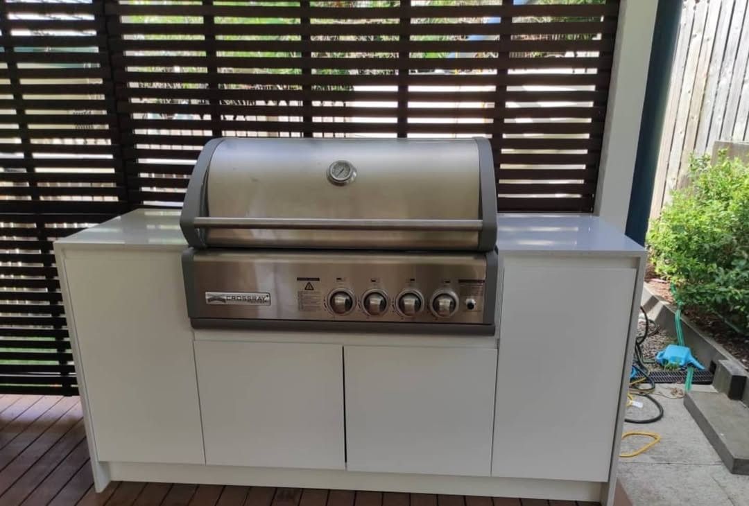 Stainless Steel Grill Built Into White Cabinet With Wooden Slat Backdrop — Canelo Cabinetry In Rocklea, QLD