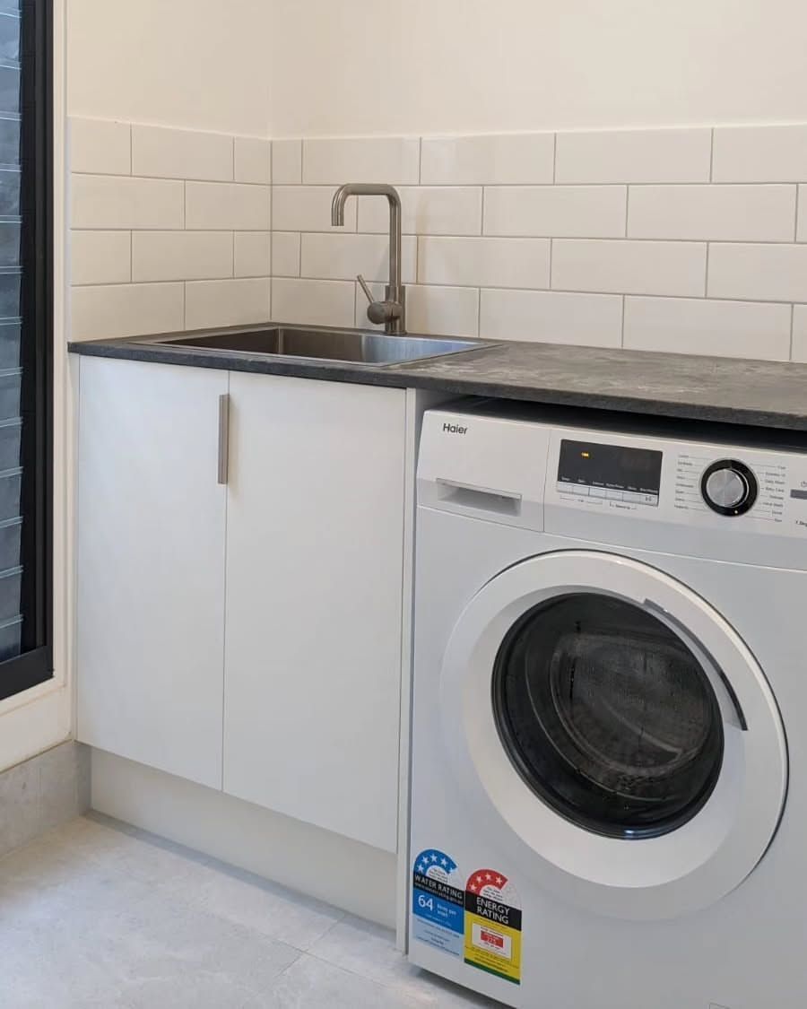 Laundry Room With a Washing Machine, Sink, White Cabinets, and Subway Tile Backsplash — Canelo Cabinetry In Rocklea, QLD