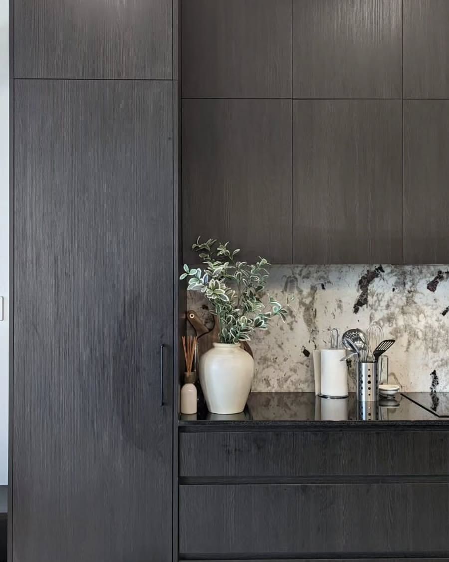 Dark Wood Kitchen Cabinets With Marble Backsplash and Vase — Canelo Cabinetry In Rocklea, QLD