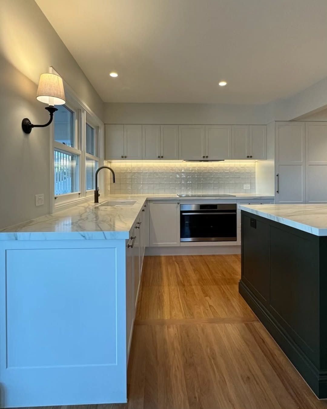 Modern Kitchen With White Cabinets, Marble Countertops, and a Dark Green Island — Canelo Cabinetry In Rocklea, QLD