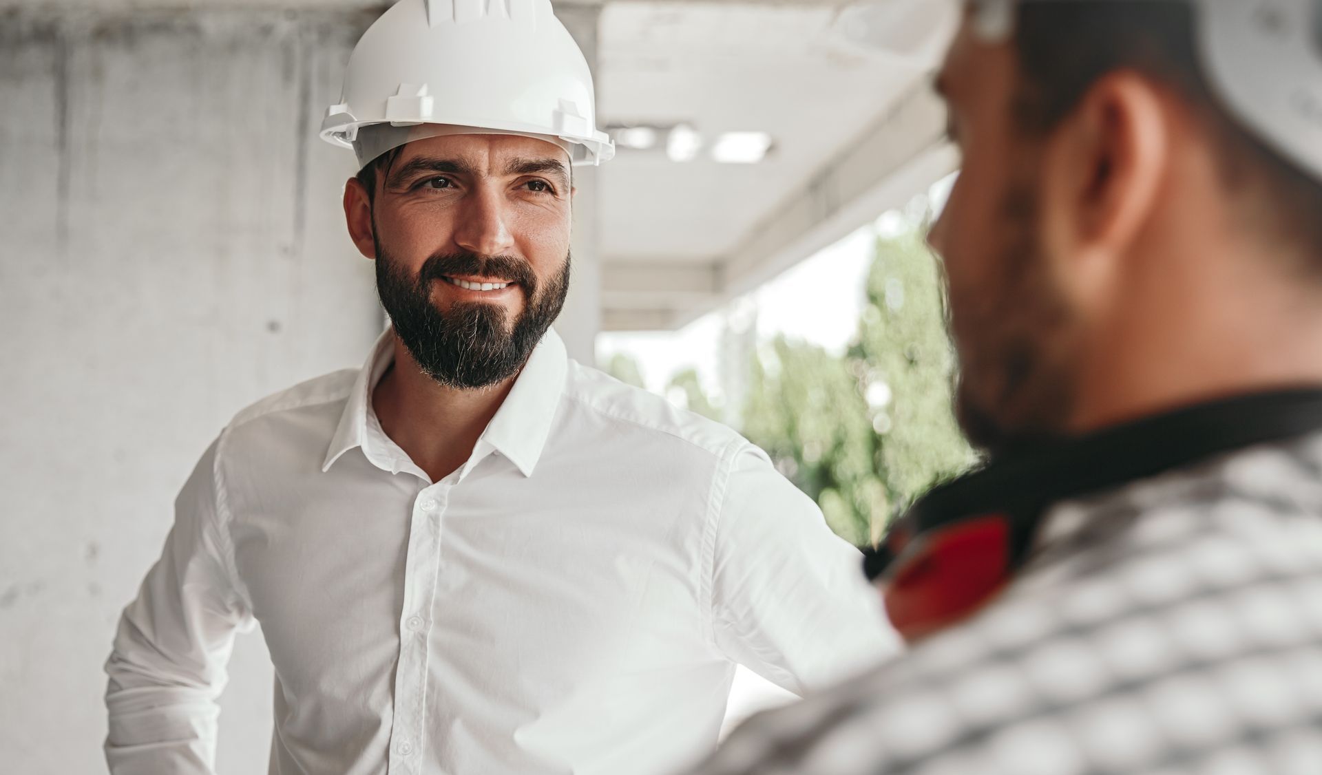 Grandparents and child loading items into a car trunk outside a building.