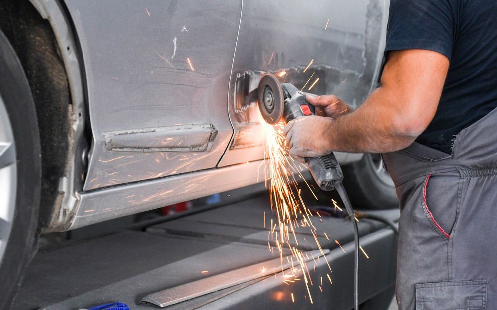Working With Angle Grinder To Fix Car Body — Atherton Smash Repair Specialist in Mareeba, QLD