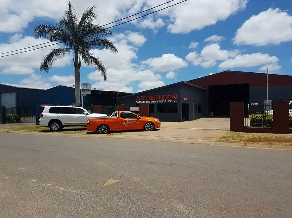 Two Cars Are Parked In Front Of The Atherton Smash Repairs Shop — Atherton Smash Repair Specialist in Atherton, QLD