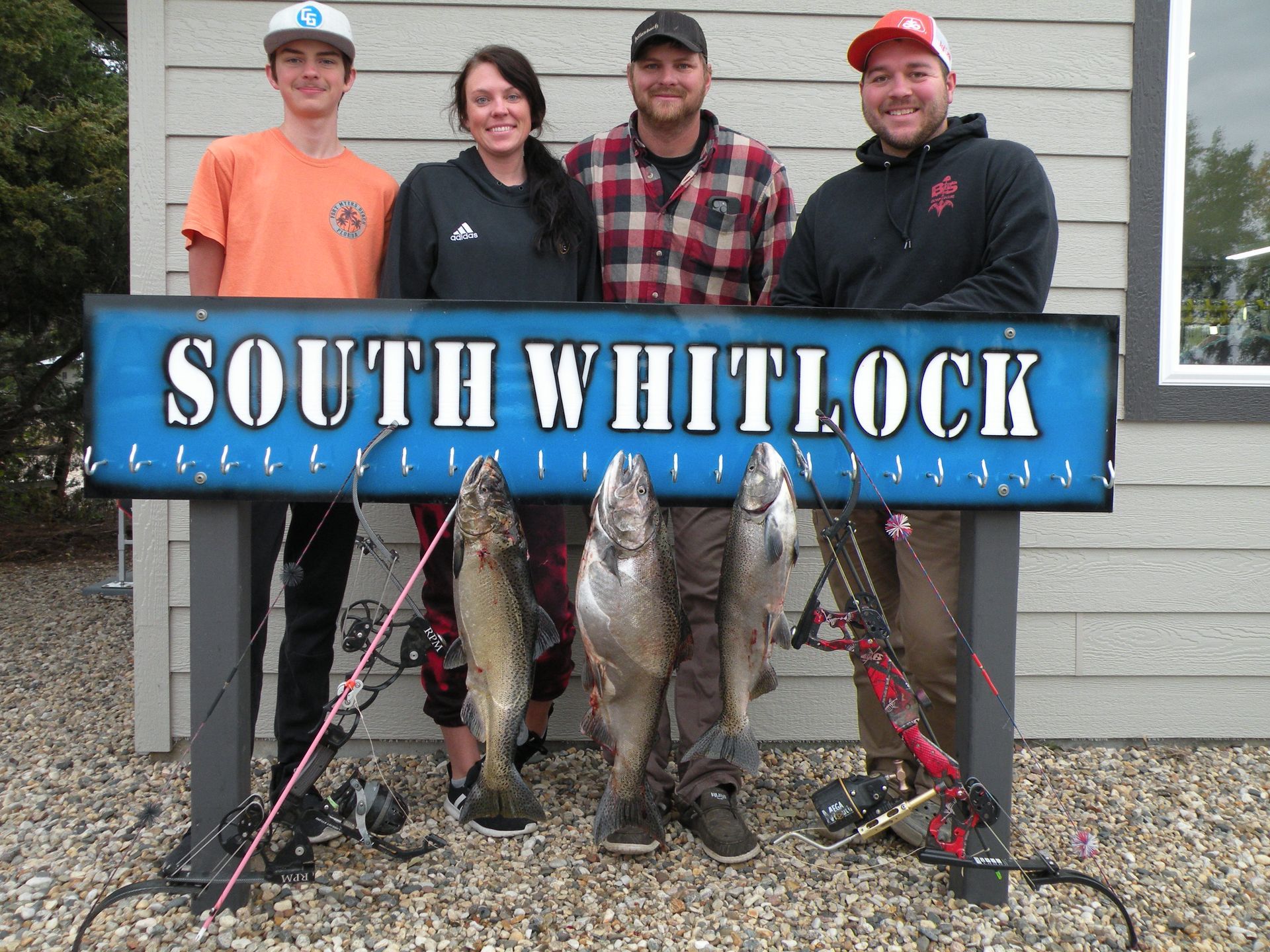 A group of people standing under a sign that says south whitlock