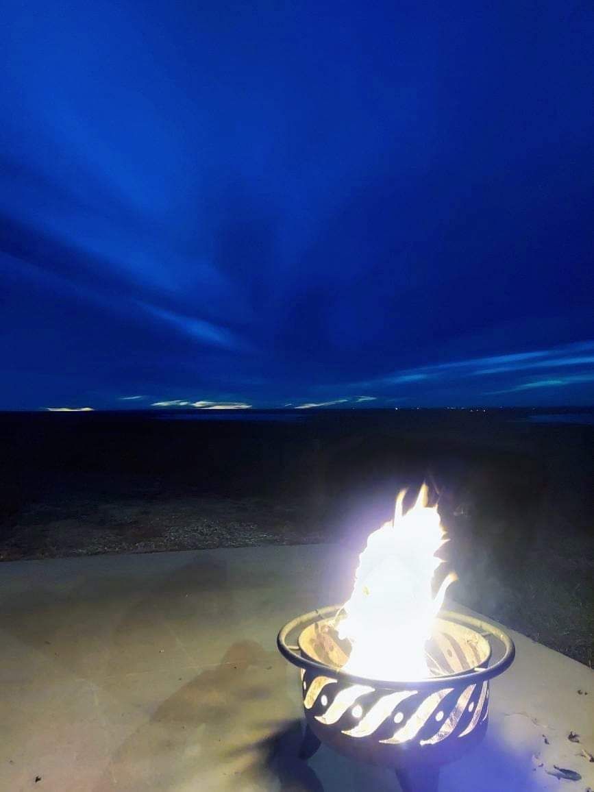 A fire pit with a blue sky in the background