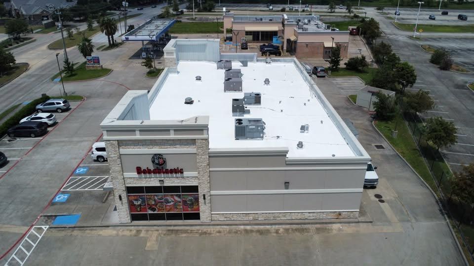 An aerial view of a building with a white roof.