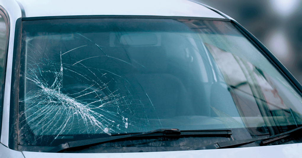 A close up of a car with a broken windshield.