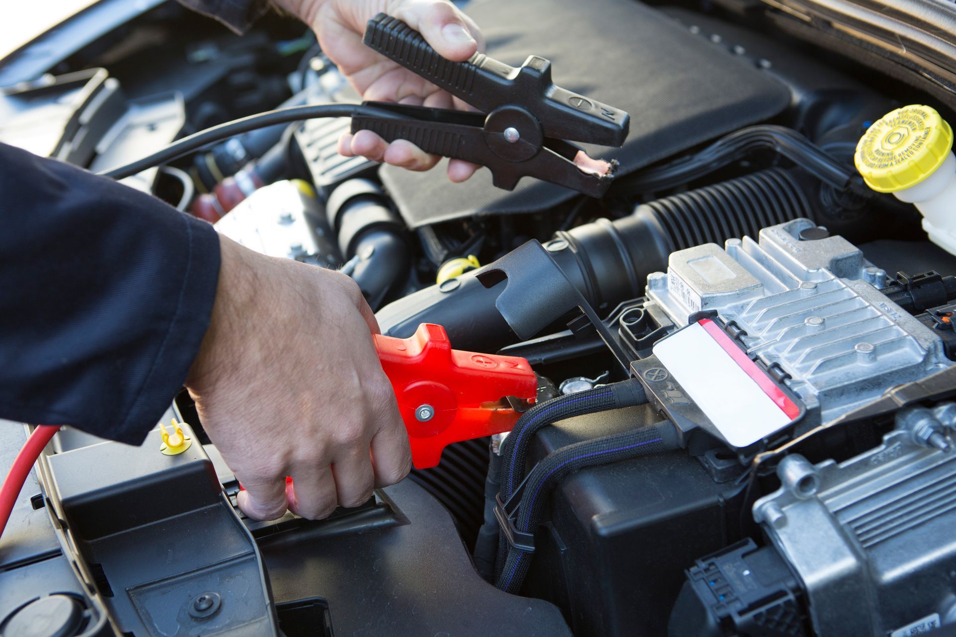 Mechanic Jumpstarting a vehicle – Land Rover Service in La Jolla