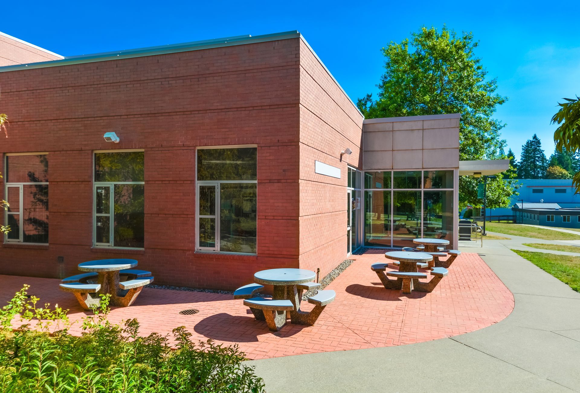 Red brick building with outdoor tables.