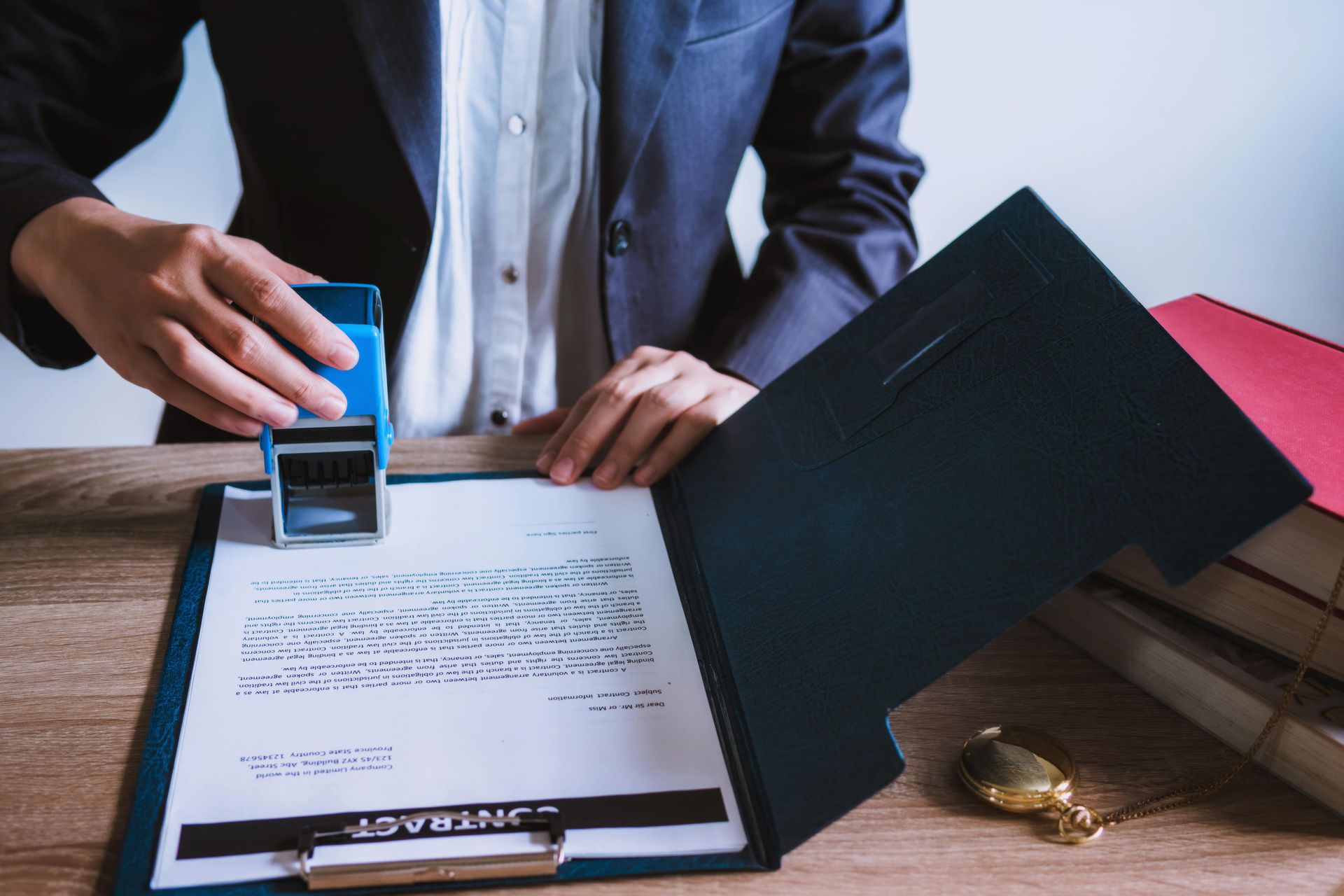 A man is stamping a document on a clipboard.