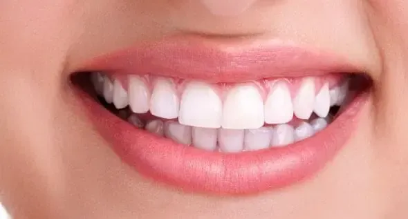 A person wearing blue gloves is working on a piece of equipment.