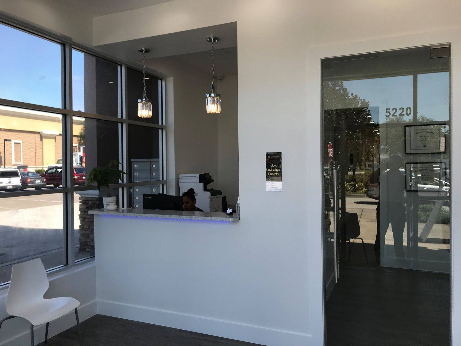 A dental office with a reception desk and a glass door.