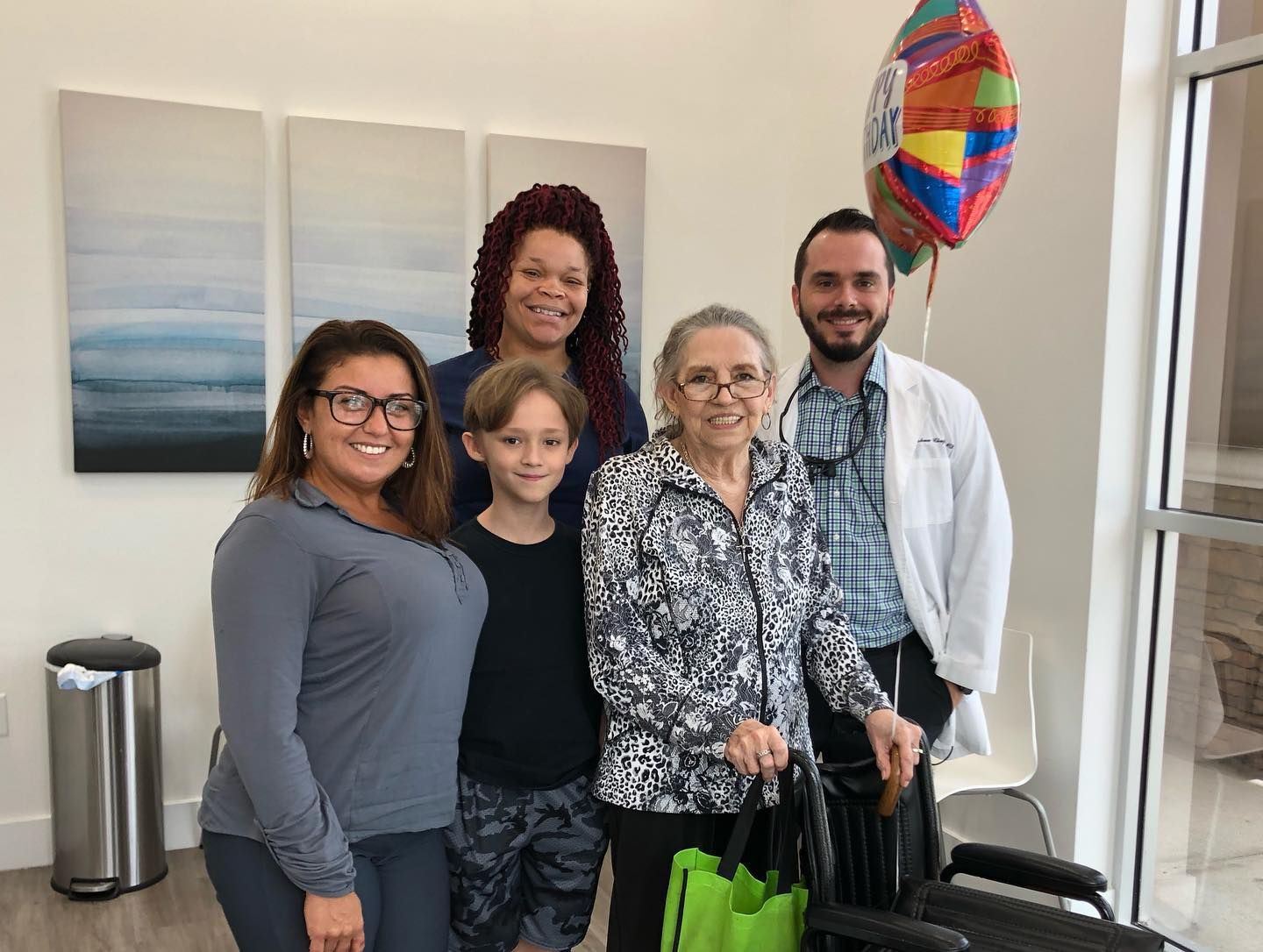 A group of people are posing for a picture in a room.