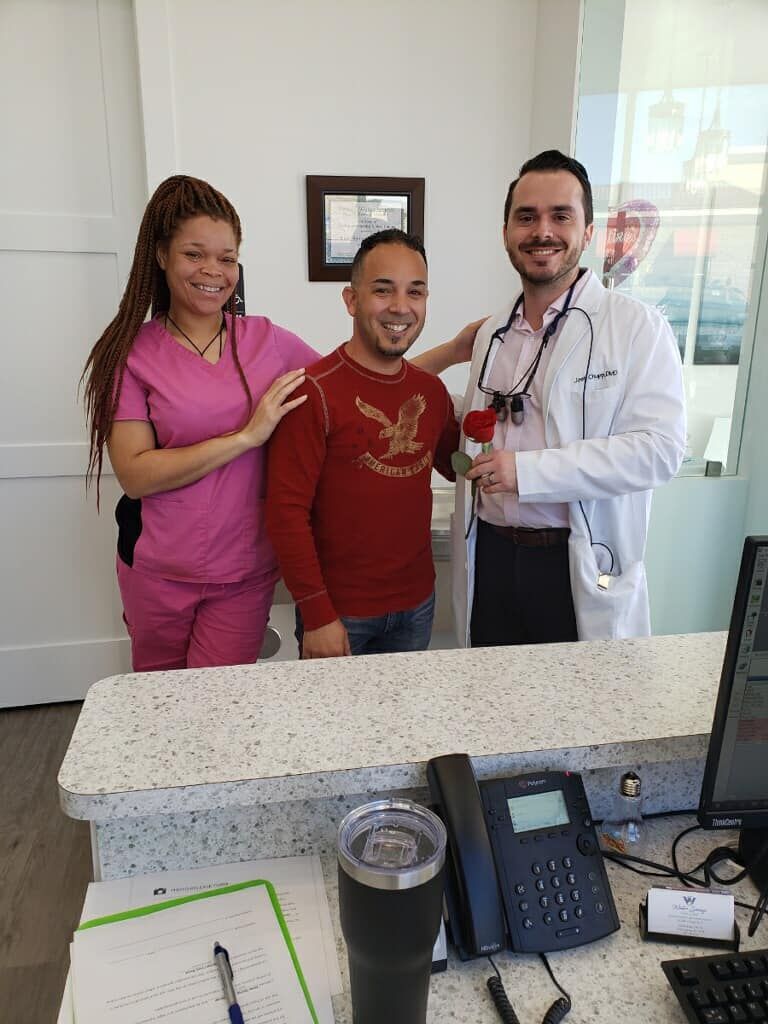 A man and a woman are standing next to each other in a dental office.