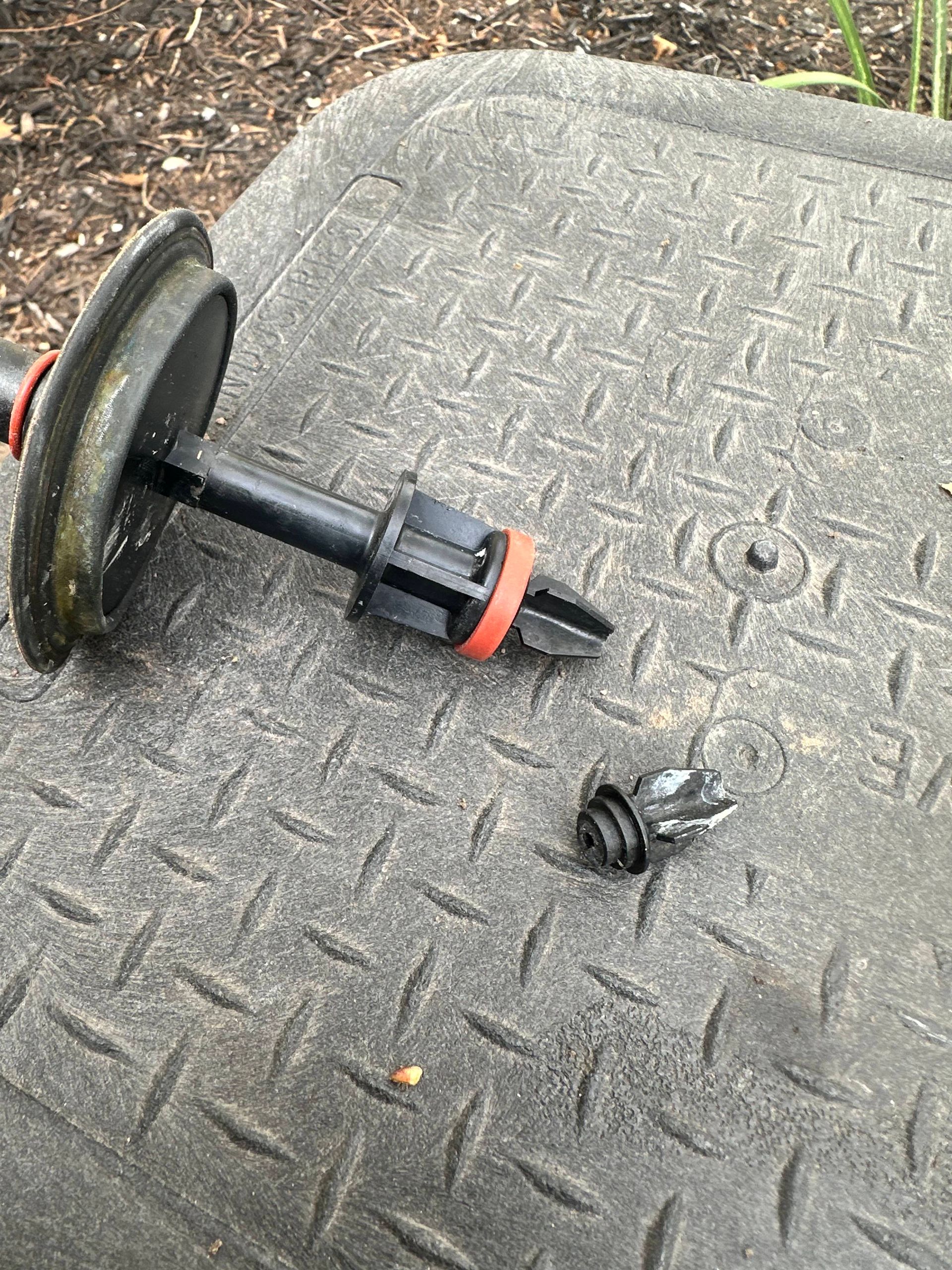 A broken dumbbell is sitting on top of a metal surface.
