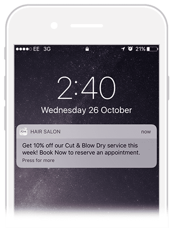 A cell phone screen shows a message from a hair salon.